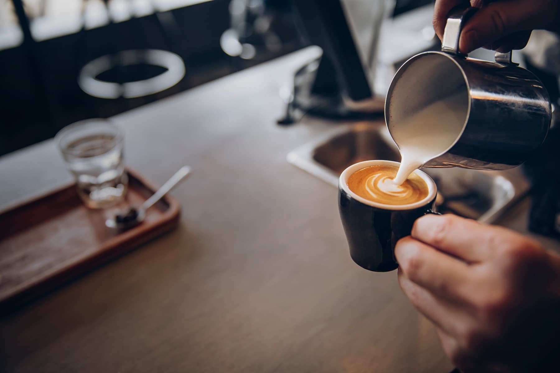 Steamed milk poured into a latte at an Espréssate mobile espresso bar
